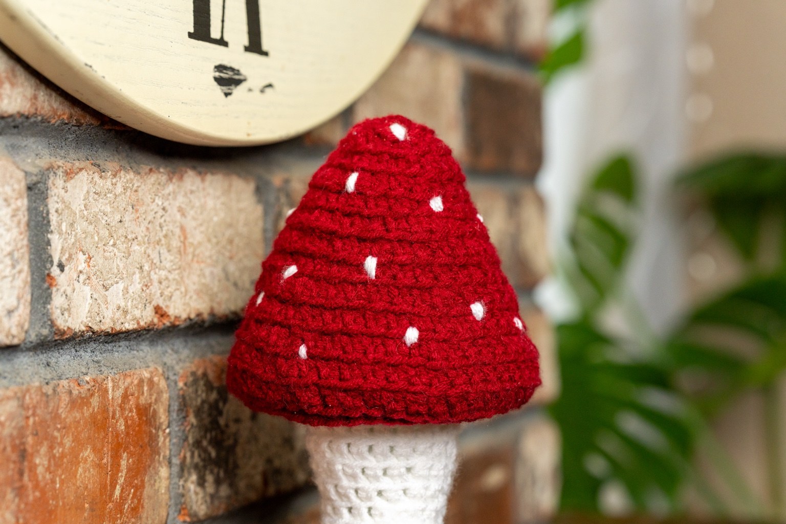 Close-up of red crochet mushroom cap
